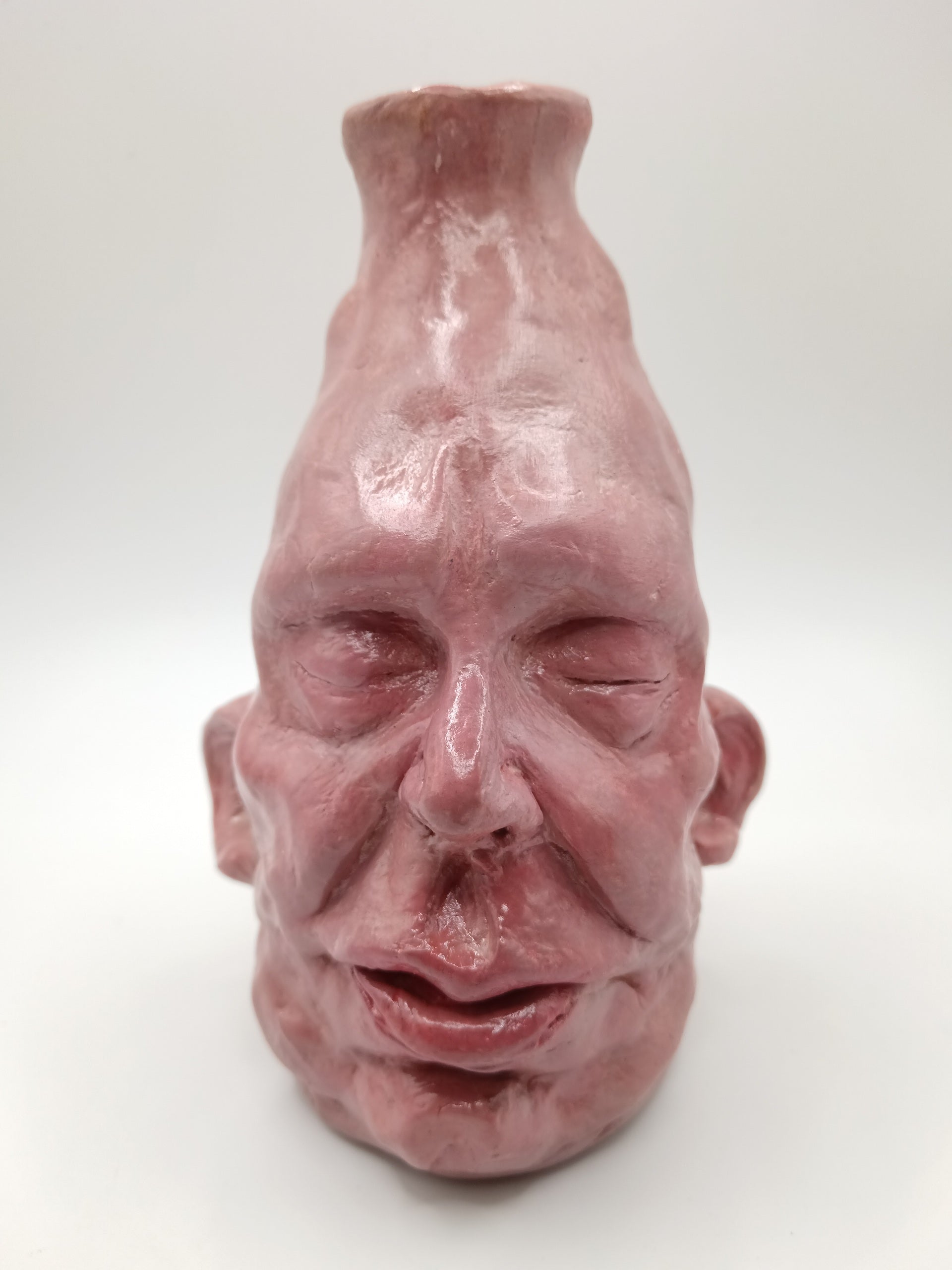handmade closed-eye clay face vase, front view