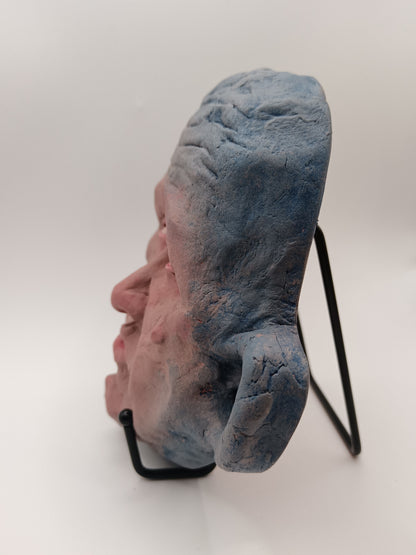 Blue face Handmade sculpture on stand, left view