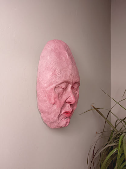 hand sculpted egghead sculpture, wall mounted side view
