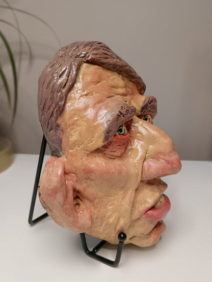 Hand sculpted clay yellow face mask sculpture side view