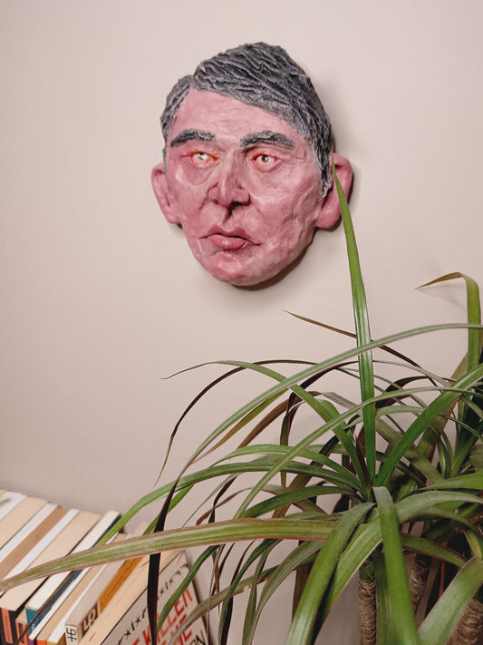 male clay sculpture  wall mounted 

