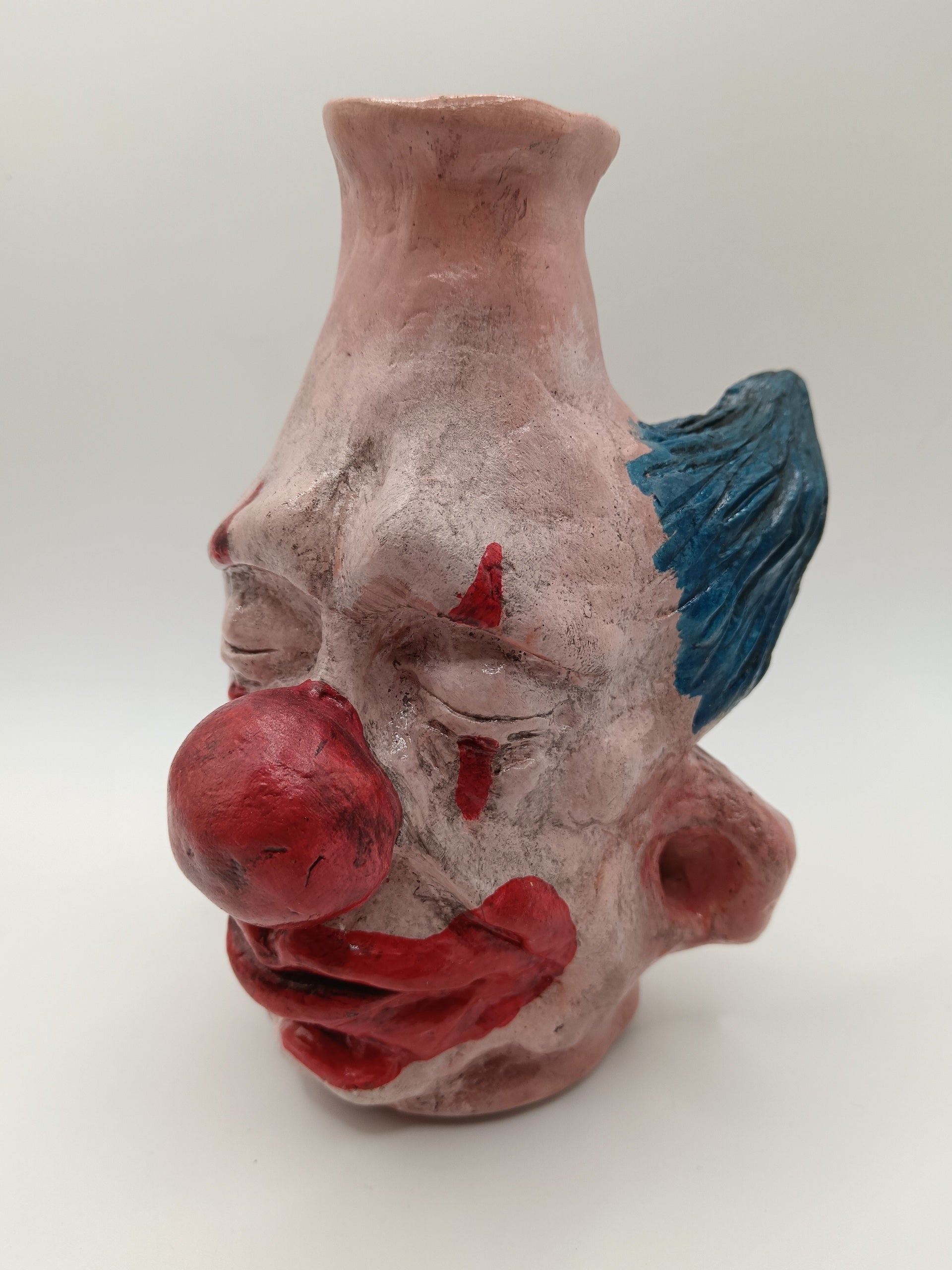 Handmade clay clown vases with blue hair side view