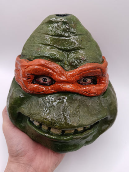 teenage mutant ninja turtles sculpture in hand
