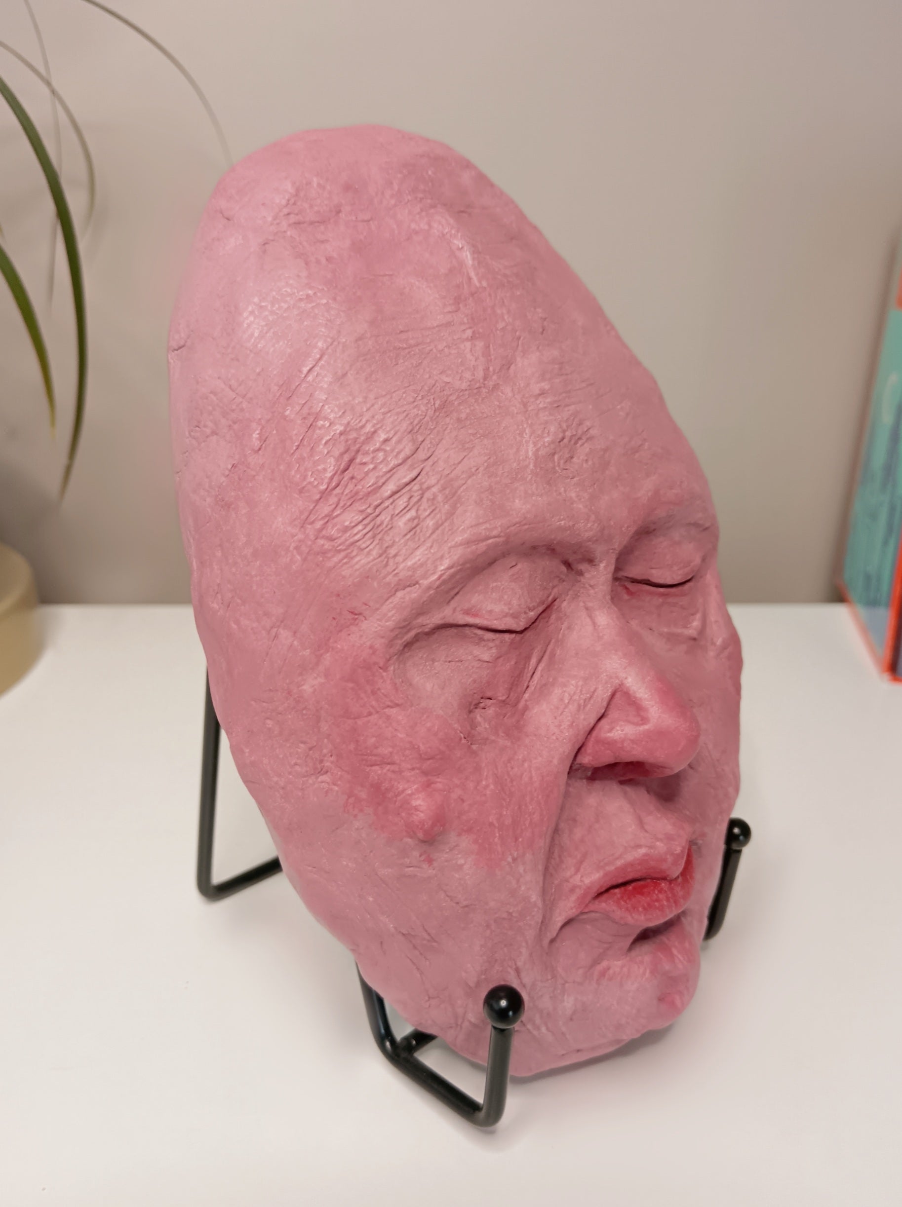 hand sculpted egghead sculpture, home setting side view