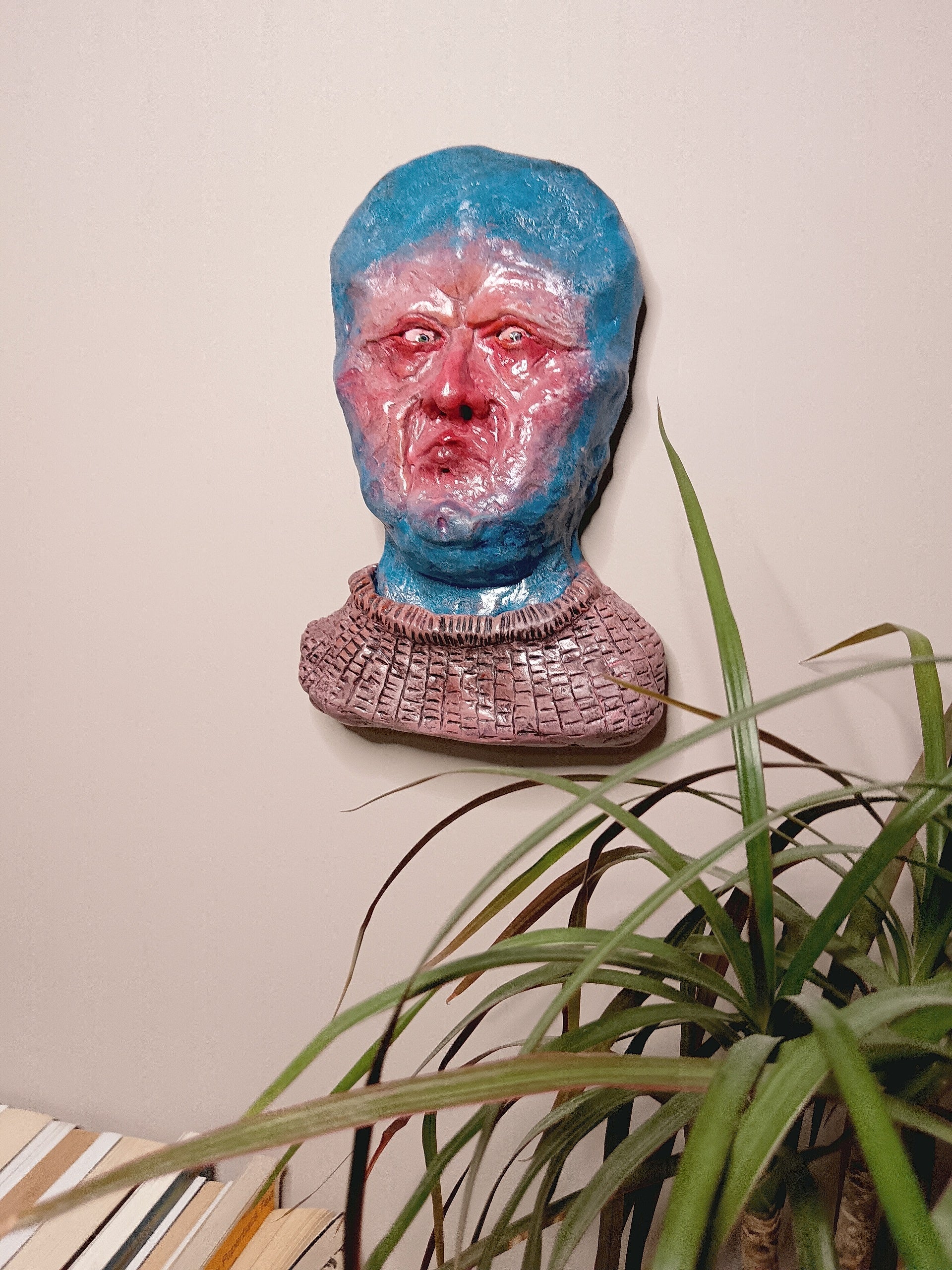 handmade clay alien sculpture, home setting wall mounted