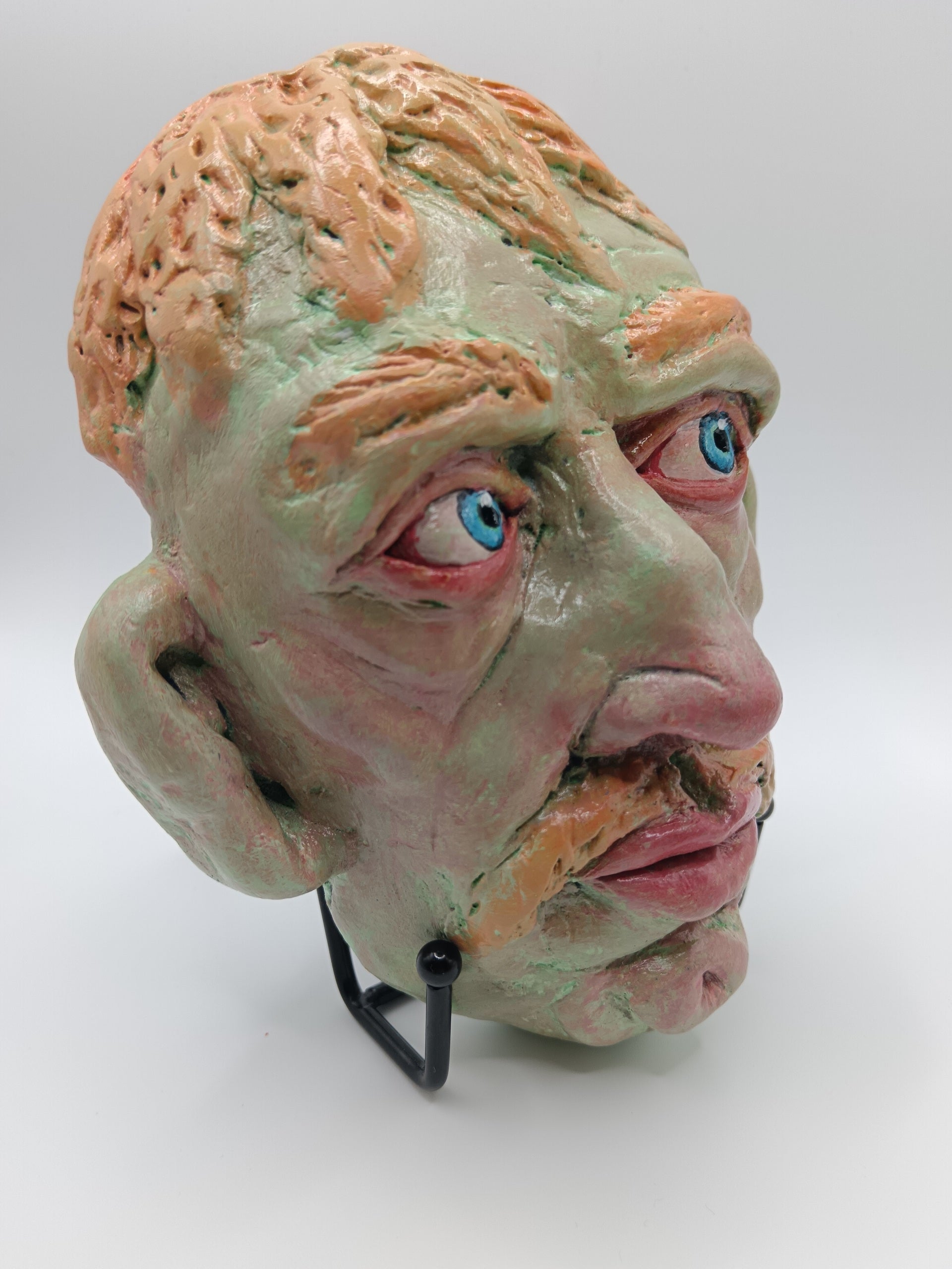 Hand sculpted green man sculpture with stand, front right