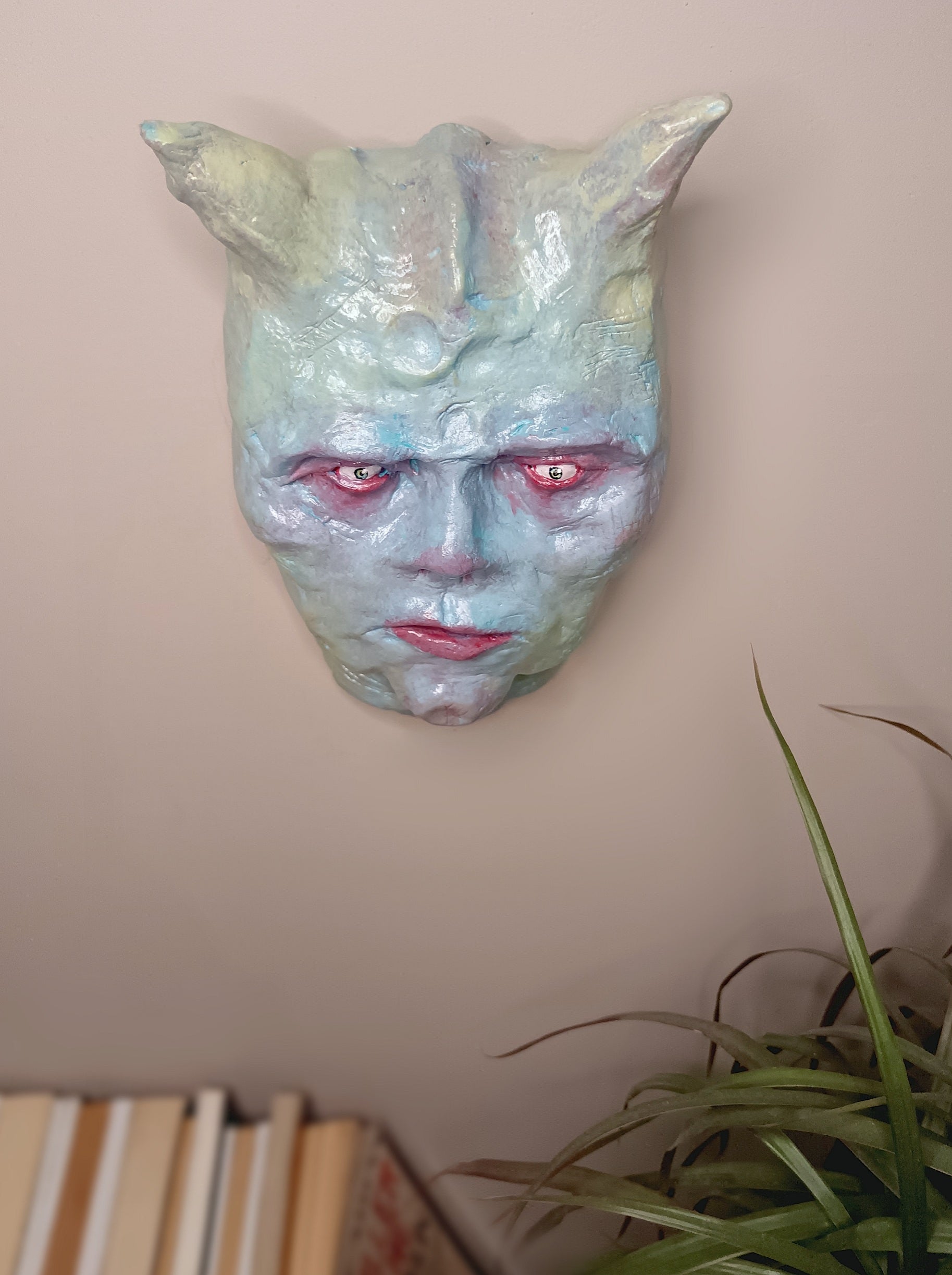 Hand sculpted clay pastel demon sculpture wall art top