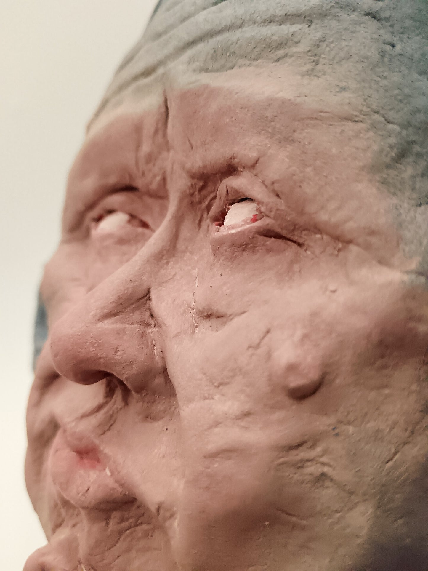 Close-up of a sculpture of a face with detailed features.