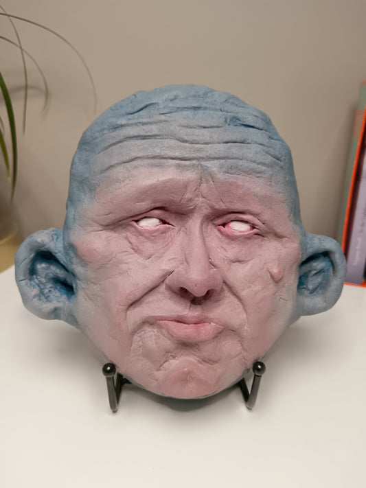 Blue face Handmade sculpture on stand, home setting